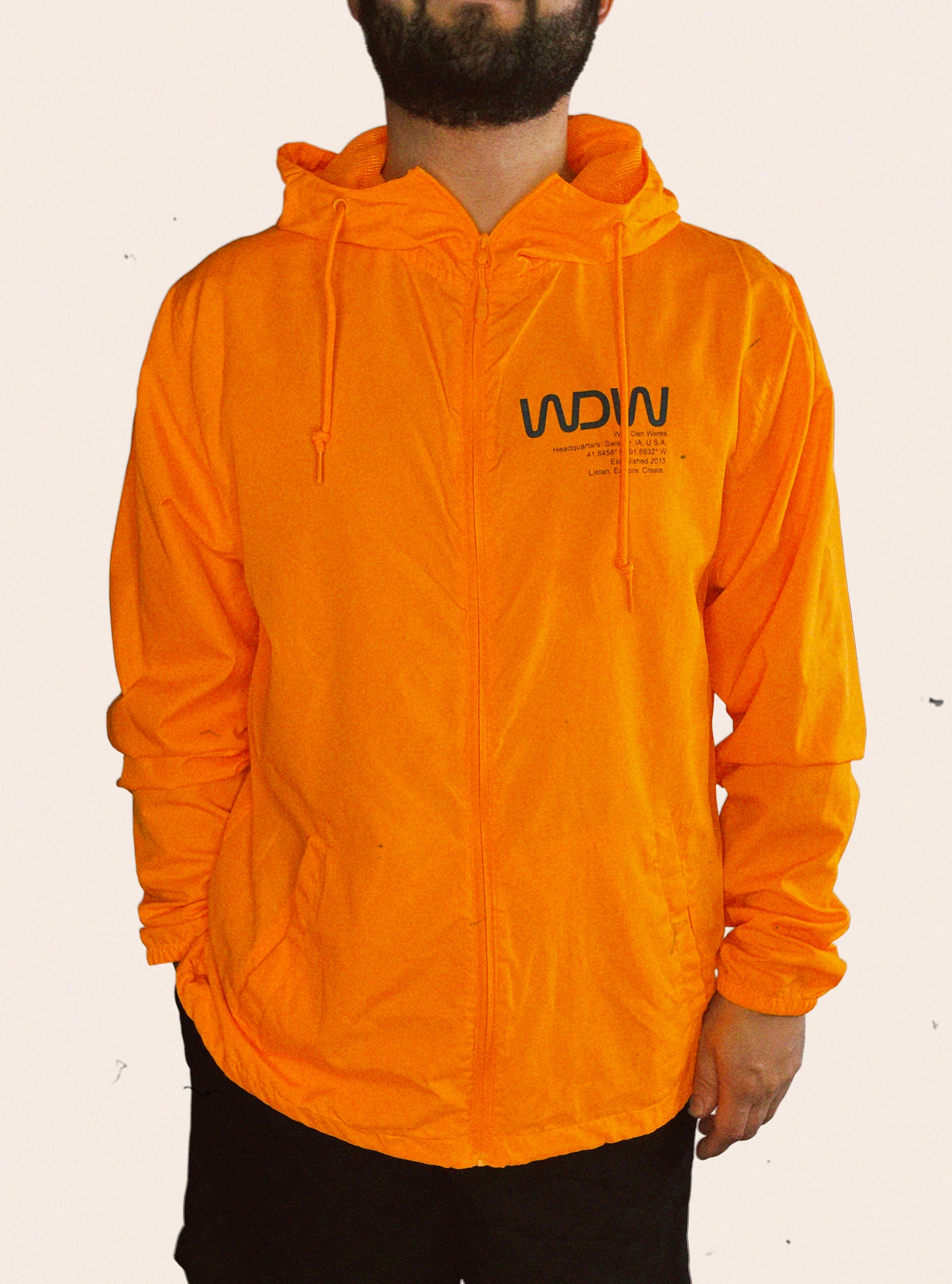 Hunter orange Independent Trading Company hooded windbreaker embellished with WDW, Wolf Den Wares, Headquarters, Swisher, IA, U.S.A., Listen. Explore. Create.