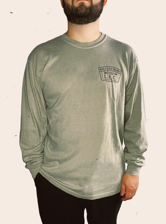 Sandstone Comfort Colors long sleeve embellished with WOLF DEN WARES, SWISHER, IA, EST 2015, L. E. C., LISTEN. EXPLORE. CREATE.